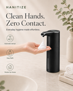 Black Hanitize automatic soap dispenser dispensing foam into a person’s hand on a modern bathroom countertop.