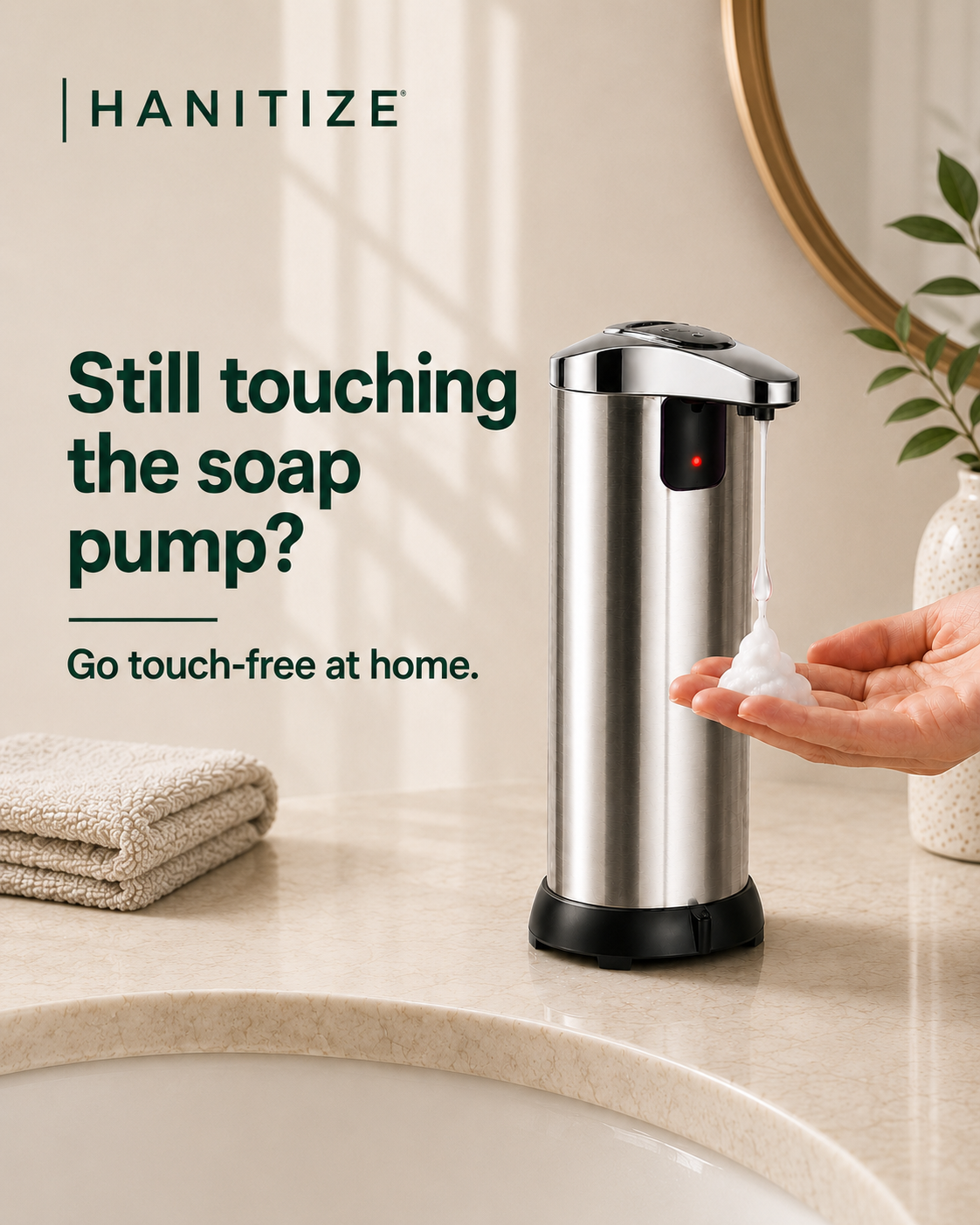 Stainless steel Hanitize automatic soap dispenser dispensing foam into a hand on a modern bathroom countertop.