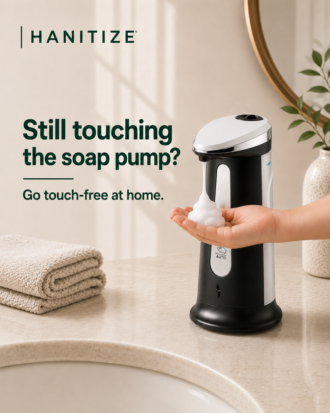 Black Hanitize automatic soap dispenser dispensing foam into a hand on a modern bathroom countertop.