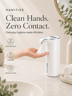 White Hanitize automatic soap dispenser dispensing foam into a person’s hand on a bright bathroom countertop.