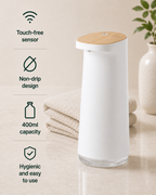 White Hanitize automatic touchless soap dispenser with a wood-effect top, non-drip design and 400ml capacity on a bathroom countertop.